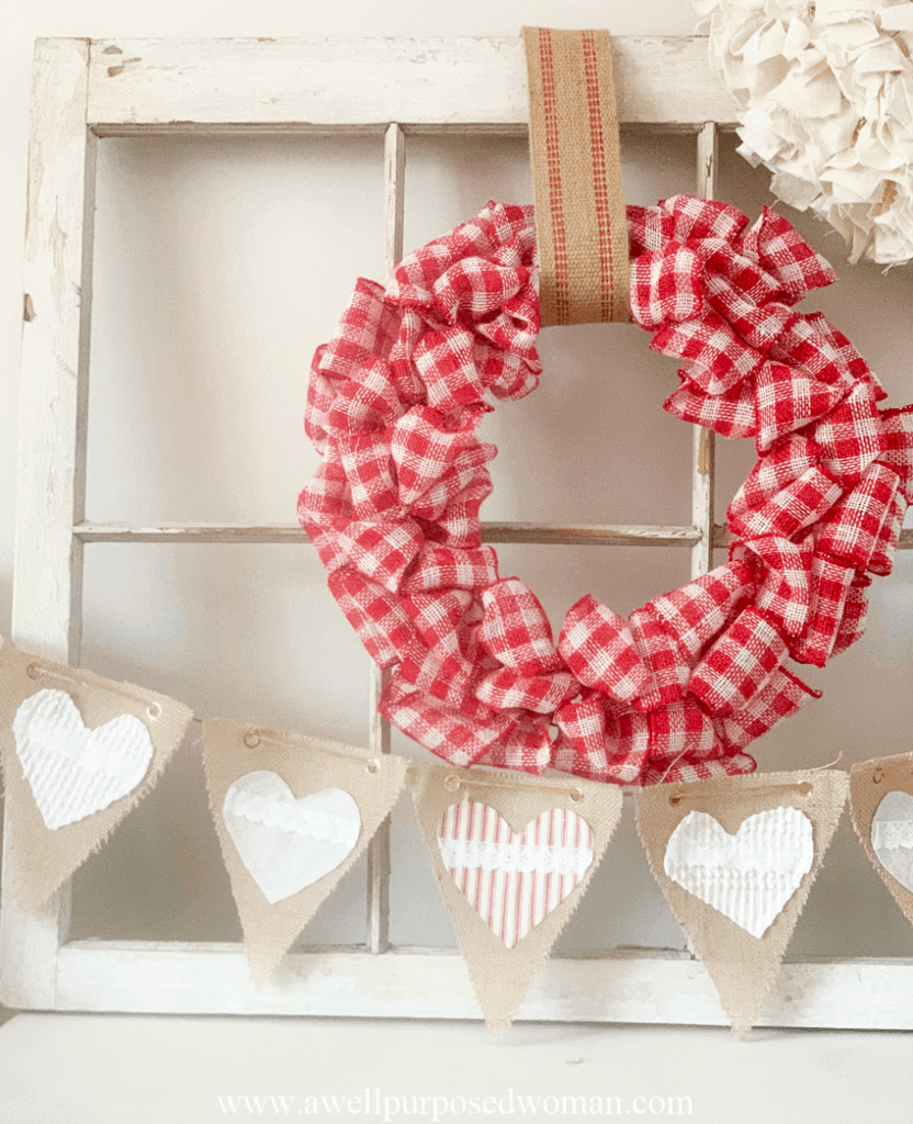 A Ribbon Wreath on an old window with a heart banner underneath