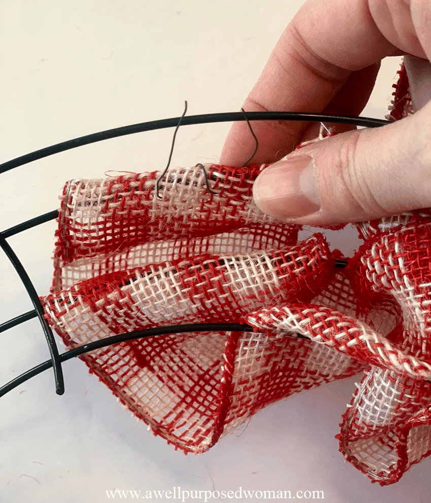 attaching the ribbon to the wire wreath form with floral wire