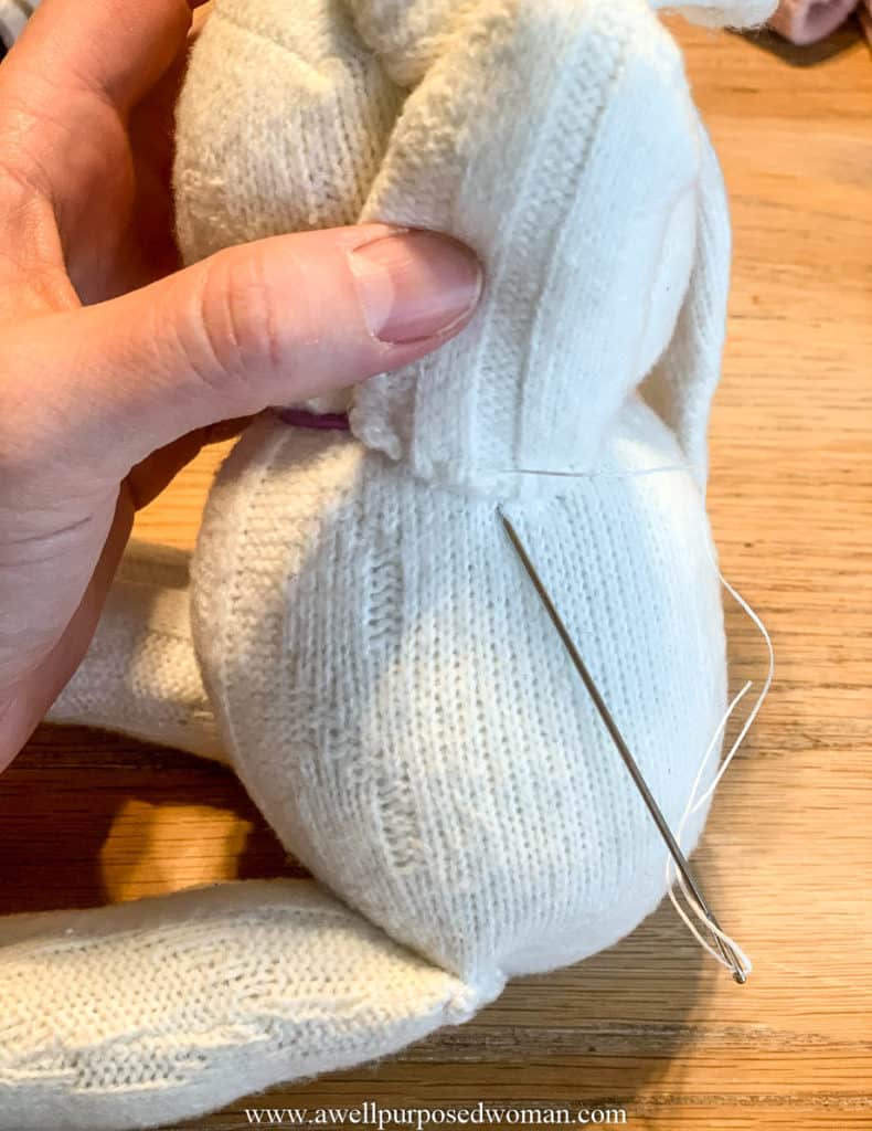 sewing an arm on sock Easter bunny
